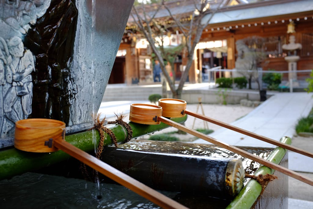 Explore a serene water basin at a traditional Japanese shrine in Fukuoka.