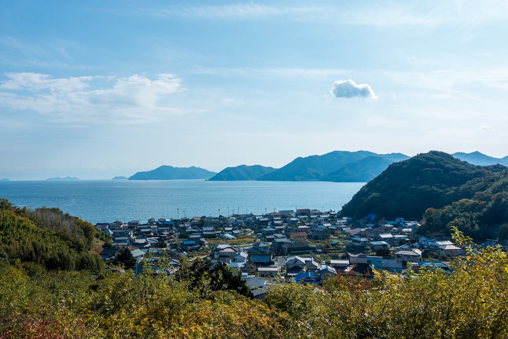 Panoramic view of Onomichi, Japan, with lush greenery and the Seto Inland Sea, showcasing natural beauty.