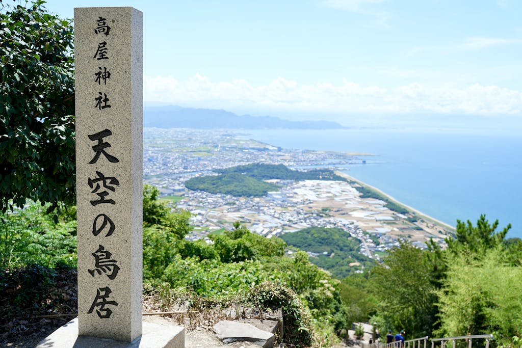Scenic view from Takaya Shrine over Japanese coastline and city.