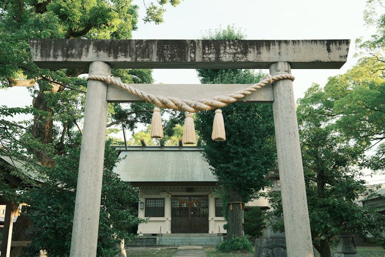 Serene view of a Shinto shrine entrance with torii gate in Toyohashi, Japan
